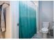 Bathroom with a toilet and turquoise shower curtain at 13651 Ashlar Slate Pl, Riverview, FL 33579