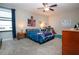 Bedroom featuring a ceiling fan, natural light, and baseball decorations at 13651 Ashlar Slate Pl, Riverview, FL 33579