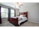 Comfortable bedroom featuring a large window, cozy bedding, and neutral decor at 13651 Ashlar Slate Pl, Riverview, FL 33579