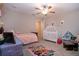 Bright bedroom featuring a crib, a ceiling fan, and decor at 13651 Ashlar Slate Pl, Riverview, FL 33579