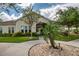 Exterior of clubhouse, featuring lush landscaping, paved walkway, and inviting entrance for community gatherings at 13651 Ashlar Slate Pl, Riverview, FL 33579