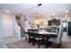 Inviting dining room featuring a stylish table, staircase, and adjacent kitchen at 13651 Ashlar Slate Pl, Riverview, FL 33579