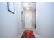 Well-lit hallway featuring tile floors and neutral walls, creating a clean and open entryway at 13651 Ashlar Slate Pl, Riverview, FL 33579