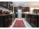 Stylish kitchen with stainless steel appliances, dark cabinets, and ample countertop space at 13651 Ashlar Slate Pl, Riverview, FL 33579