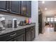 Coffee bar area with granite countertops and black cabinets at 13651 Ashlar Slate Pl, Riverview, FL 33579