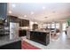 Open kitchen with black cabinetry, stainless steel appliances, and a large center island for entertaining at 13651 Ashlar Slate Pl, Riverview, FL 33579