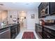 Modern kitchen featuring black cabinets, stainless steel appliances and granite countertops at 13651 Ashlar Slate Pl, Riverview, FL 33579