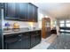 Kitchen features black cabinets, granite countertops, and stainless steel appliances at 13651 Ashlar Slate Pl, Riverview, FL 33579
