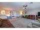 Spacious living room with comfortable seating, a ceiling fan, and plenty of natural light at 13651 Ashlar Slate Pl, Riverview, FL 33579