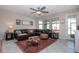 Inviting living room with a leather sectional, area rug, and view of the backyard at 13651 Ashlar Slate Pl, Riverview, FL 33579