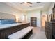 Spacious main bedroom featuring a tray ceiling, carpet, and access to bathroom and hallway at 13651 Ashlar Slate Pl, Riverview, FL 33579