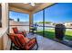Screened-in patio with seating and a grill overlooking the backyard at 13651 Ashlar Slate Pl, Riverview, FL 33579