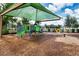 A fun playground with slides, climbing equipment, and covered picnic area for outdoor entertainment at 13651 Ashlar Slate Pl, Riverview, FL 33579