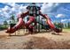 Playground featuring twisting red slides for thrilling outdoor adventures in a Gathering-friendly community at 13651 Ashlar Slate Pl, Riverview, FL 33579