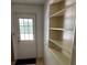 Entryway featuring a door to the outside and built-in shelves for storage at 1379 Pine St, Clearwater, FL 33756