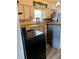 Cozy kitchen featuring white cabinetry, wood countertops and modern appliances at 1379 Pine St, Clearwater, FL 33756