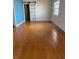 Spacious living room with rich hardwood floors and a unique sliding barn door at 1379 Pine St, Clearwater, FL 33756