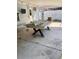 Covered patio space with concrete flooring, a large table, and view of backyard at 1379 Pine St, Clearwater, FL 33756