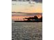 A vibrant sunset featuring a pier with palm trees at 1379 Pine St, Clearwater, FL 33756