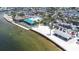 Beautiful aerial view of beachfront restaurant with outdoor seating, sandy beach, and clear blue waters at 13926 Helen Ave, Hudson, FL 34667