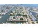 High aerial view shows a waterfront neighborhood with interconnected canals and docks, near open water at 13926 Helen Ave, Hudson, FL 34667
