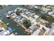 Aerial view showcases waterfront homes with boat docks along winding canals connected to open bay at 13926 Helen Ave, Hudson, FL 34667