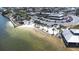 Picturesque aerial view shows waterfront restaurant with a sandy beach, parking lot, and a marina at 13926 Helen Ave, Hudson, FL 34667