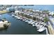 Stunning aerial view of a marina filled with boats, surrounded by lush landscaping and waterfront properties at 13926 Helen Ave, Hudson, FL 34667