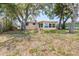 View of the back of the house, with plenty of shade trees at 13926 Helen Ave, Hudson, FL 34667