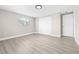 Neutral bedroom featuring new floors, a bright window, and ample closet space at 13926 Helen Ave, Hudson, FL 34667