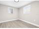 Neutral bedroom featuring new floors, baseboard trim, and bright windows at 13926 Helen Ave, Hudson, FL 34667