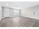 Bright living room featuring stylish gray flooring, fresh paint, and recessed lighting at 13926 Helen Ave, Hudson, FL 34667