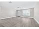 Bright living room featuring stylish gray flooring, fresh paint, and recessed lighting at 13926 Helen Ave, Hudson, FL 34667