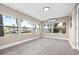 Bright sunroom features large windows offering serene water views and tile flooring at 13926 Helen Ave, Hudson, FL 34667