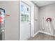 Utility room with access to the backyard, featuring a water heater and laundry hookups at 13926 Helen Ave, Hudson, FL 34667