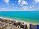 View of condos along the sandy beach with beautiful turquoise water backdrop at 14900 Gulf Blvd # 212, Madeira Beach, FL 33708