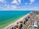 Overhead shot of beachfront condos near sandy beach and the turquoise ocean at 14900 Gulf Blvd # 212, Madeira Beach, FL 33708