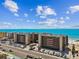 Panoramic aerial view of beachfront property, with clear blue ocean views and well-manicured grounds at 14900 Gulf Blvd # 212, Madeira Beach, FL 33708
