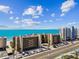 A stunning aerial view showcasing beachfront condos with convenient parking and well-kept grounds at 14900 Gulf Blvd # 212, Madeira Beach, FL 33708