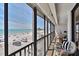 Comfortable balcony with seating offering expansive ocean and beach views at 14900 Gulf Blvd # 212, Madeira Beach, FL 33708