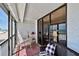 Relaxing balcony featuring a table, seating area, and breathtaking beach views at 14900 Gulf Blvd # 212, Madeira Beach, FL 33708