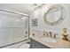 Well-lit bathroom featuring a granite vanity, unique mirror, and a glass-enclosed shower at 14900 Gulf Blvd # 212, Madeira Beach, FL 33708