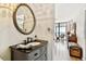 Elegant bathroom vanity with dark countertop and view of ocean from connected bedroom at 14900 Gulf Blvd # 212, Madeira Beach, FL 33708