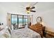 A sunlit bedroom with a balcony offers stunning ocean views and a seating area at 14900 Gulf Blvd # 212, Madeira Beach, FL 33708
