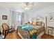 Bright bedroom with warm accents, a ceiling fan, and a rocking chair at 14900 Gulf Blvd # 212, Madeira Beach, FL 33708