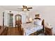 Comfortable bedroom features wood floors and a connected bathroom with a tiled walk-in shower at 14900 Gulf Blvd # 212, Madeira Beach, FL 33708