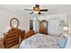 A bedroom features wood floors, a large dresser with an oval mirror, and a closet at 14900 Gulf Blvd # 212, Madeira Beach, FL 33708