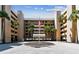 Condo exterior with palm trees and flagpole with parking lot at 14900 Gulf Blvd # 212, Madeira Beach, FL 33708