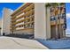 Modern exterior featuring multiple balconies, lush landscaping, and direct beach access at 14900 Gulf Blvd # 212, Madeira Beach, FL 33708