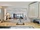 Kitchen granite countertop and view to Living Room with ocean views at 14900 Gulf Blvd # 212, Madeira Beach, FL 33708